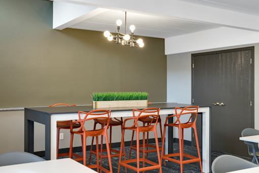 A kitchen with a bar area and chairs.