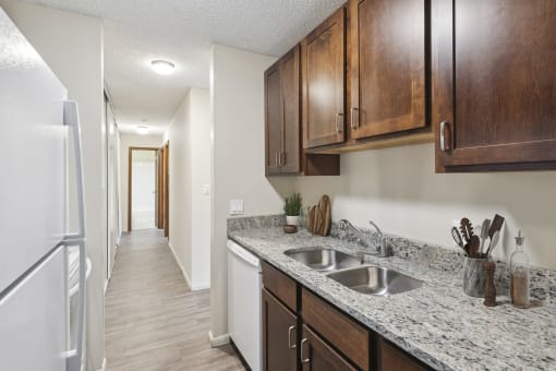 an empty kitchen with wood cabinets and a white refrigerator and sink at Silver Lake, New Brighton, 55112