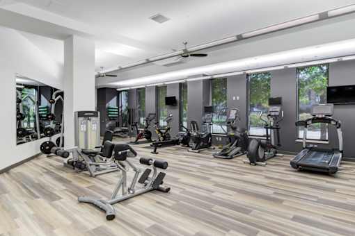 A gym with a variety of exercise equipment.