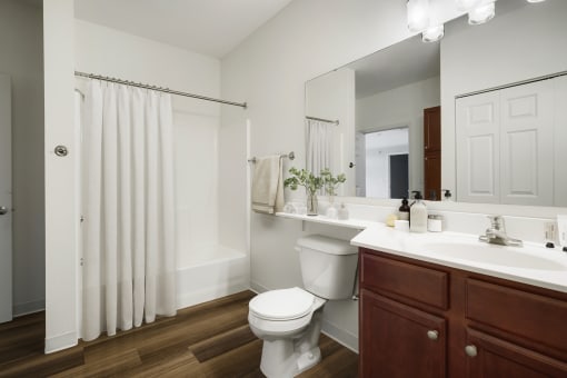 a bathroom with a toilet and a sink at The Gables at Park Pointe, St. Louis Park