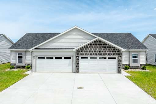 A two-car garage is attached to a house.at Concord Crossing, Lafayette, 47909  