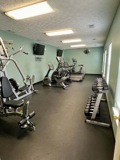 a gym with several machines and weights on the floor at Shenandoah Properties in Lafayette, IN 47905