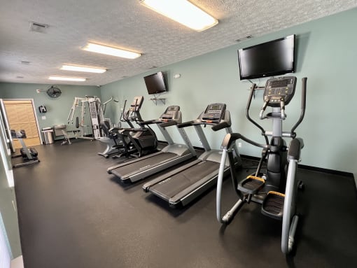 a gym with cardio equipment and a tv at Shenandoah Properties in Lafayette, IN 47905