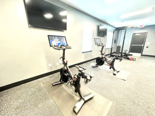 a room with three treadmills and a tv on the wall at Murdock Gardens Apartments, Lafayette, IN 47904
