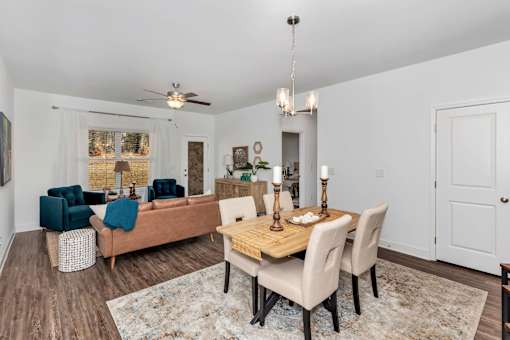 A dining room with a wooden table and chairs.