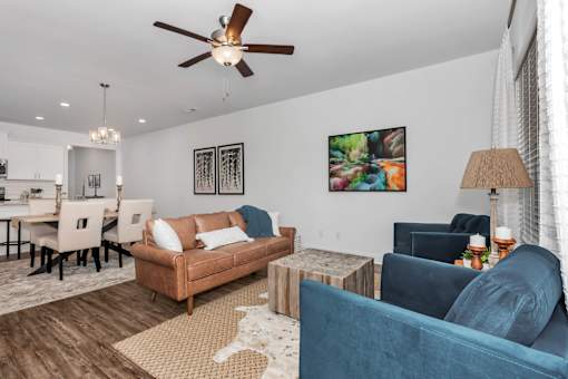 A living room with a brown couch and a blue couch.