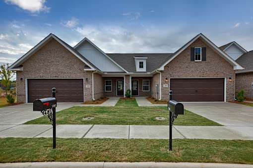 A house with a grey roof and a brown brick exterior.