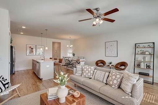 A living room with a grey couch and a wooden coffee table.