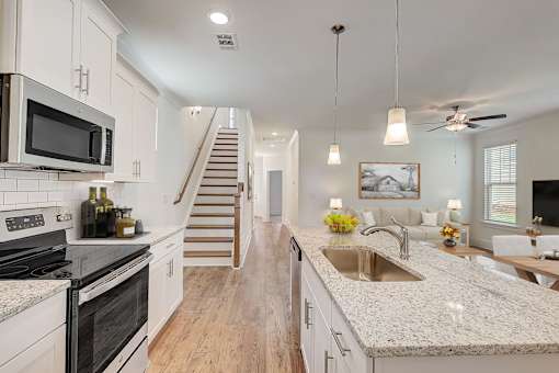 A kitchen with a stove top oven and a microwave.