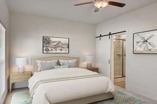 A bedroom with a bed, two lamps, and two pictures on the wall.