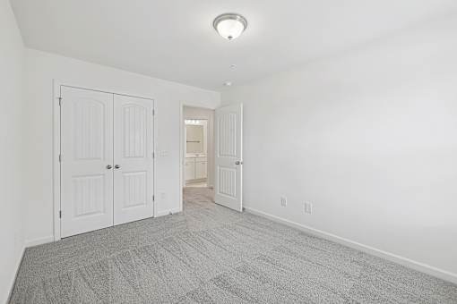 A room with a carpeted floor and white walls.