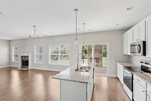 A modern kitchen with white cabinets and a large island.