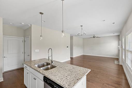 A kitchen with a granite countertop and a sink.