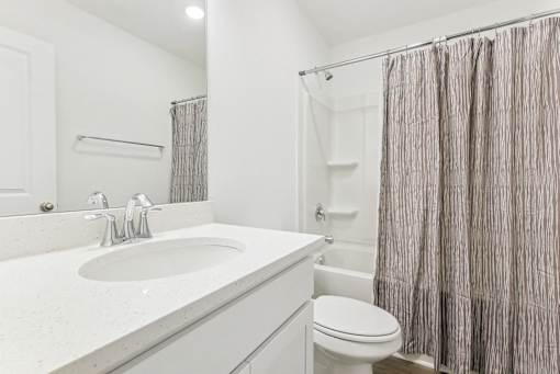 Sleek bathroom with soaking tub and shower combination