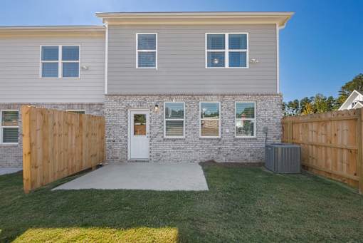 Spacious backyard with privacy fence and patio area