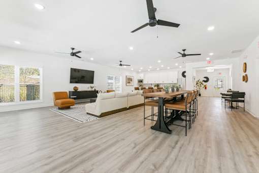 Bright open-concept clubhouse with modern ceiling fans