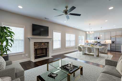 A modern living room with a fireplace and a television.