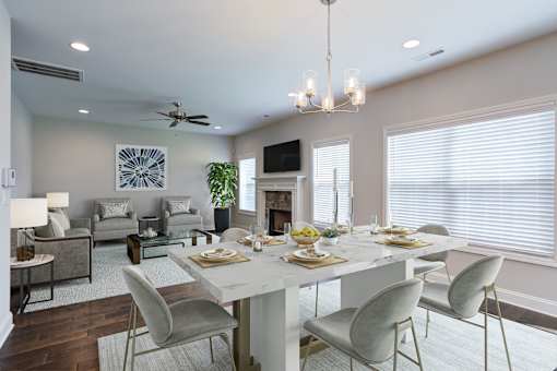 A dining room with a white table and chairs.