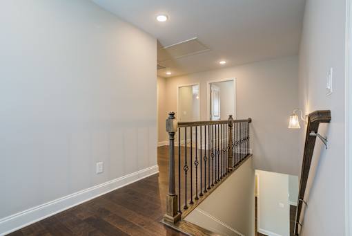 A staircase with a black railing and wooden steps.