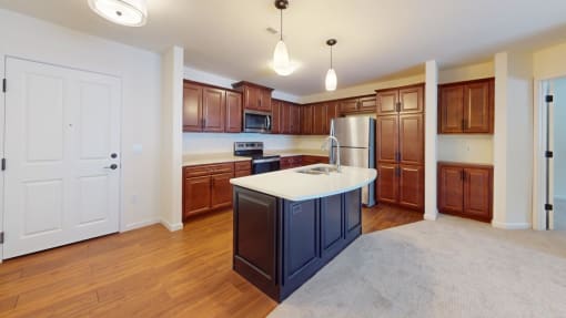 an empty kitchen with a large island in the middle