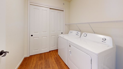a washer and dryer in a room with a closet