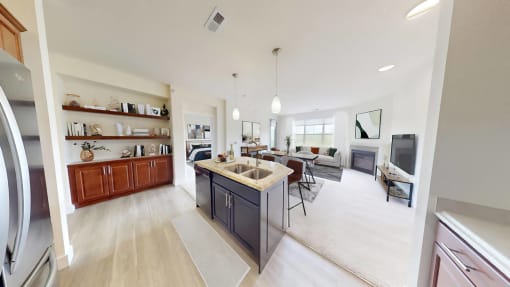 a kitchen and living room with a counter top in a house