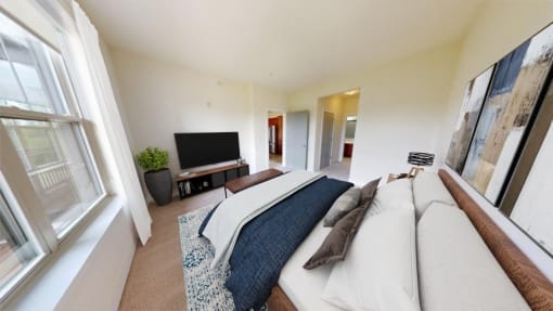 a bedroom with a bed and a tv