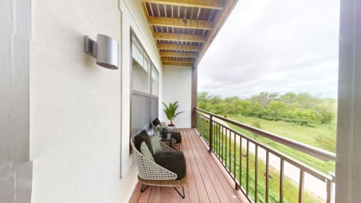 a balcony with a couch and a cat on it