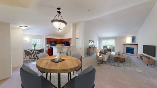 a living room and dining room with a table and chairs