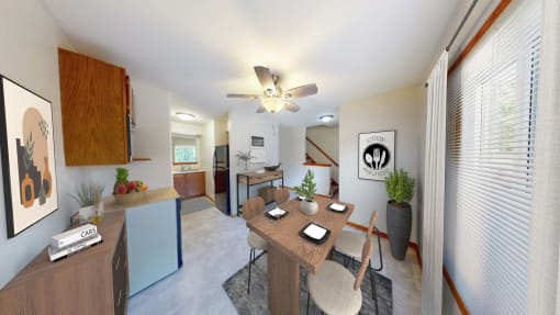 a dining room and living room with a table and a ceiling fan