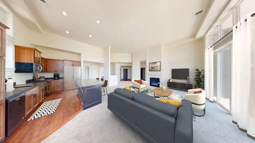a living room with a couch and a kitchen with a table