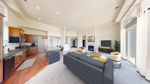a living room with a couch and a kitchen with a table