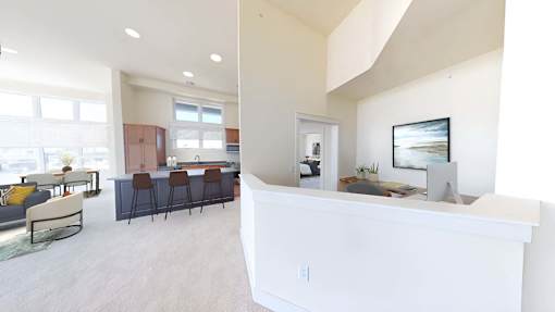 a kitchen and living room with a counter and a table with chairs