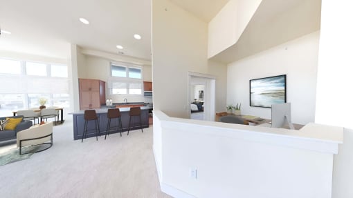 a kitchen and living room with a counter and a table with chairs