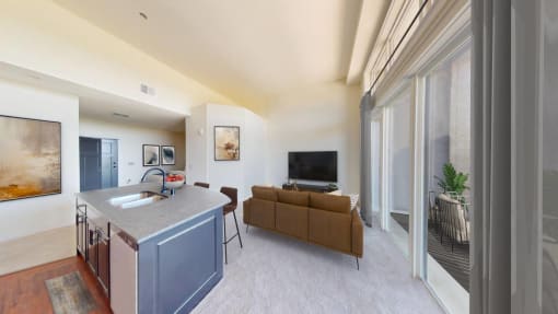a living room with a kitchen and a couch