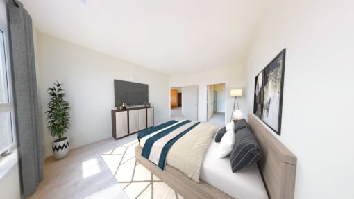 a bedroom with a bed and a tv