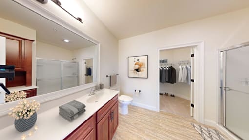 A bathroom with a white countertop and a white toilet.