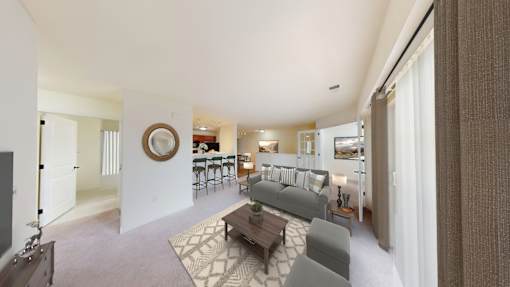 A living room with a grey couch and a coffee table.