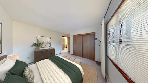 A bedroom with a bed, nightstand, and a painting on the wall.