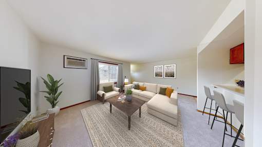 A living room with a couch, chairs, and a coffee table.