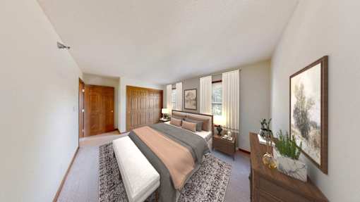 A bedroom with a large bed and a painting on the wall.