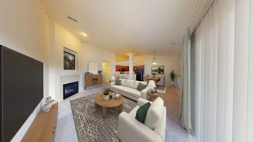 A modern living room with a fireplace and a large window.