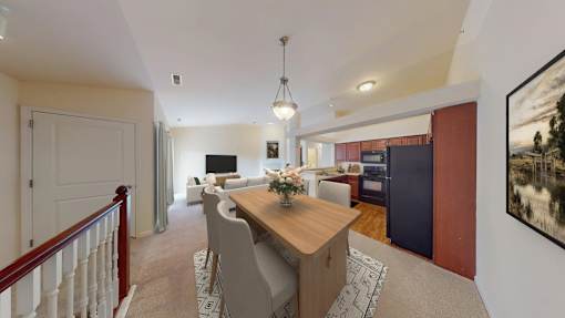 A dining room with a wooden table and chairs.