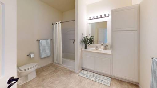 A bathroom with a toilet, sink, and shower.