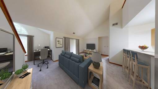 A living room with a grey couch and a wooden table.