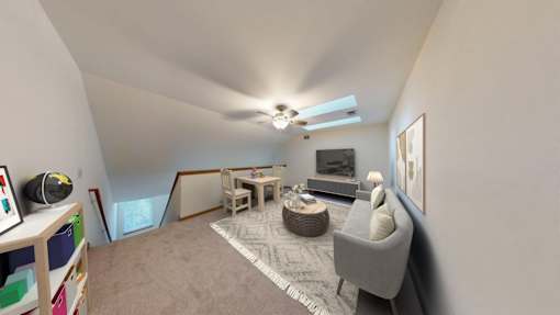 A living room with a grey sofa, a coffee table, and a television.