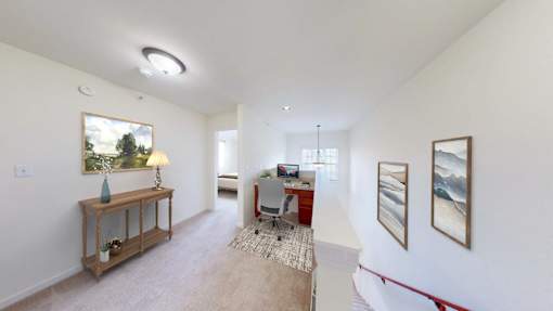 A room with a table, chairs, and pictures on the wall.
