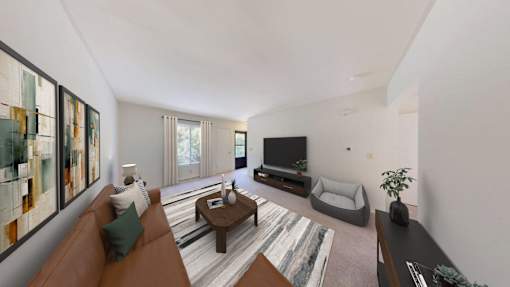 A living room with a brown couch, a coffee table, a television, and a rug.