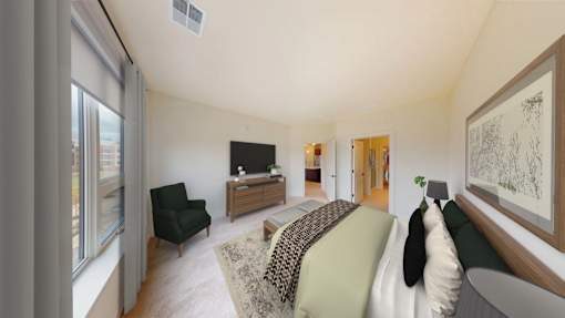 A living room with a black chair and a green couch.