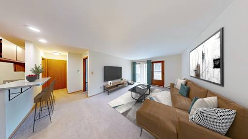 A living room with a brown couch and a television.